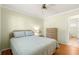 Comfortable bedroom featuring neutral walls, a ceiling fan, and ensuite bathroom access at 17664 Se 105Th Terrace, Summerfield, FL 34491