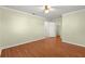 Bedroom with wood floors, ceiling fan and walk in closet at 17664 Se 105Th Terrace, Summerfield, FL 34491