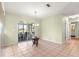 Bright dining area with tiled floors, sliding glass doors to the lanai, and a view of the well-maintained backyard at 17664 Se 105Th Terrace, Summerfield, FL 34491