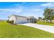 Charming single-story home with a well-manicured lawn and attached two-car garage at 17664 Se 105Th Terrace, Summerfield, FL 34491