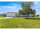 Charming single-story home boasts a well-manicured lawn, mature tree, and inviting curb appeal at 17664 Se 105Th Terrace, Summerfield, FL 34491