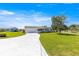 Lovely home with a driveway, well-maintained lawn, and a beautiful, mature tree in the front yard at 17664 Se 105Th Terrace, Summerfield, FL 34491