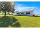 Beautifully landscaped front yard with lush green grass surrounding a well-maintained home at 17664 Se 105Th Terrace, Summerfield, FL 34491