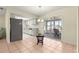 Bright kitchen featuring a refrigerator, white cabinetry, and a view of the sunroom through sliding glass doors at 17664 Se 105Th Terrace, Summerfield, FL 34491