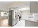 Efficient kitchen with stainless steel appliances, white cabinets, and tile flooring, adjoining a cozy breakfast nook at 17664 Se 105Th Terrace, Summerfield, FL 34491