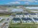 Aerial view of a community featuring two-story townhomes and scenic views of a nearby lake at 1819 Terrapin Rd, Ocoee, FL 34761