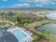 Aerial view of a community pool area with lounge chairs, tables, and lush greenery at 1819 Terrapin Rd, Ocoee, FL 34761