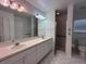 Bathroom with double vanity, large mirror and shower at 1895 Country Club Blvd, Mount Dora, FL 32757