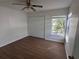 Well-lit bedroom with double door closet and window at 1895 Country Club Blvd, Mount Dora, FL 32757