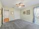 Bright bedroom with gray carpet, double doors, and ceiling fan at 2005 Palo Alto Ave, The Villages, FL 32159