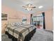 Main bedroom with access to sunroom and ceiling fan at 2005 Palo Alto Ave, The Villages, FL 32159