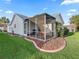 House with screened porch and landscaped yard at 2005 Palo Alto Ave, The Villages, FL 32159