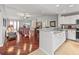 Open kitchen with white cabinets, granite countertops, and hardwood floors at 2005 Palo Alto Ave, The Villages, FL 32159