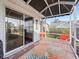 Screened porch with seating area and view of backyard at 2005 Palo Alto Ave, The Villages, FL 32159