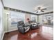Sunroom with hardwood floors, leather seating and large windows at 2005 Palo Alto Ave, The Villages, FL 32159