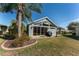 Backyard view with patio, grill, and screened enclosure at 2402 Bennettsville Ln, The Villages, FL 32162