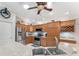 Modern kitchen with stainless steel appliances and light wood cabinets at 2402 Bennettsville Ln, The Villages, FL 32162