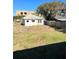 Large backyard behind a white house with a wooden fence at 248 E Magnolia St, Groveland, FL 34736