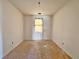 Empty bedroom with wood flooring and a window at 248 E Magnolia St, Groveland, FL 34736