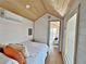 Bright bedroom with a queen bed and access to living area at 248 E Magnolia St, Groveland, FL 34736