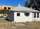 White house with metal roof and small yard at 248 E Magnolia St, Groveland, FL 34736