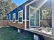 Blue tiny home exterior with wood siding and a deck at 248 E Magnolia St, Groveland, FL 34736