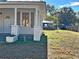 Charming white house with a porch and a spacious yard at 248 E Magnolia St, Groveland, FL 34736