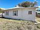 White siding home with gray shutters and a spacious yard at 248 E Magnolia St, Groveland, FL 34736