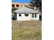 White house with metal roof and grassy yard at 248 E Magnolia St, Groveland, FL 34736