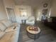 Comfortable living room featuring neutral-toned furniture and a view into the kitchen at 24825 Pine Hl, Leesburg, FL 34748