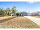 Gray house with a yard and trees in background at 2555 Sw 154Th Place Rd, Ocala, FL 34473