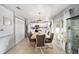 Kitchen with white cabinets, stainless steel appliances, and a dining area at 2555 Sw 154Th Place Rd, Ocala, FL 34473