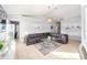 Bright living room features a large sectional sofa and a glass-top coffee table at 2555 Sw 154Th Place Rd, Ocala, FL 34473