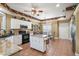 Kitchen boasts granite counters, white cabinets, and island at 2587 Tremont Drive, Eustis, FL 32726