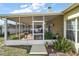 Exterior view of a home with a screened patio and landscaped yard at 2587 Tremont Drive, Eustis, FL 32726