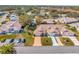 Wide aerial view of a community, highlighting a single Gathering home's position at 26607 Racquet Cir, Leesburg, FL 34748