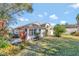 Landscaped backyard with lush greenery and a home exterior view at 26607 Racquet Cir, Leesburg, FL 34748