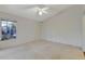 Bright and airy bedroom with carpeted floors and a ceiling fan at 26607 Racquet Cir, Leesburg, FL 34748