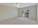 Bedroom with sliding doors leading to a private balcony at 26607 Racquet Cir, Leesburg, FL 34748