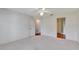 Large bedroom with ceiling fan and access to another bathroom at 26607 Racquet Cir, Leesburg, FL 34748