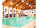 Large community room with wood ceilings and a green floor at 26607 Racquet Cir, Leesburg, FL 34748
