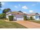 Well maintained single Gathering home with attached garage and neat landscaping at 26607 Racquet Cir, Leesburg, FL 34748