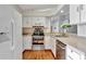Bright kitchen with stainless steel appliances and light wood flooring at 26607 Racquet Cir, Leesburg, FL 34748