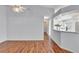 Living room with hardwood floors and kitchen view at 26607 Racquet Cir, Leesburg, FL 34748