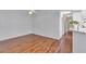 Living room with hardwood floors and kitchen view at 26607 Racquet Cir, Leesburg, FL 34748