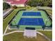 Community tennis courts with seating at 26607 Racquet Cir, Leesburg, FL 34748