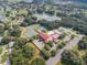 Aerial view of community clubhouse, pool, and tennis courts at 27039 Racquet Cir, Leesburg, FL 34748