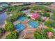 Aerial view of community clubhouse, pool, and tennis courts at 27039 Racquet Cir, Leesburg, FL 34748