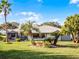 Lovely backyard with lush lawn and mature landscaping at 27039 Racquet Cir, Leesburg, FL 34748