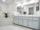 Bright bathroom with double vanity and a relaxing bathtub at 27039 Racquet Cir, Leesburg, FL 34748